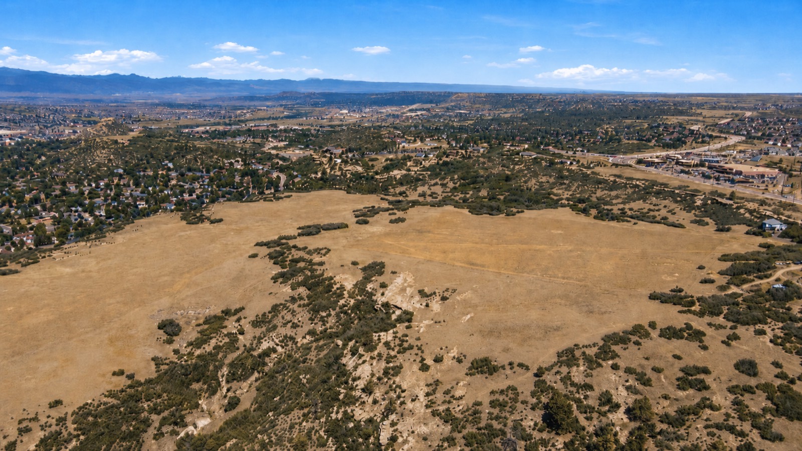 Aerial view across the property toward town and the foothills